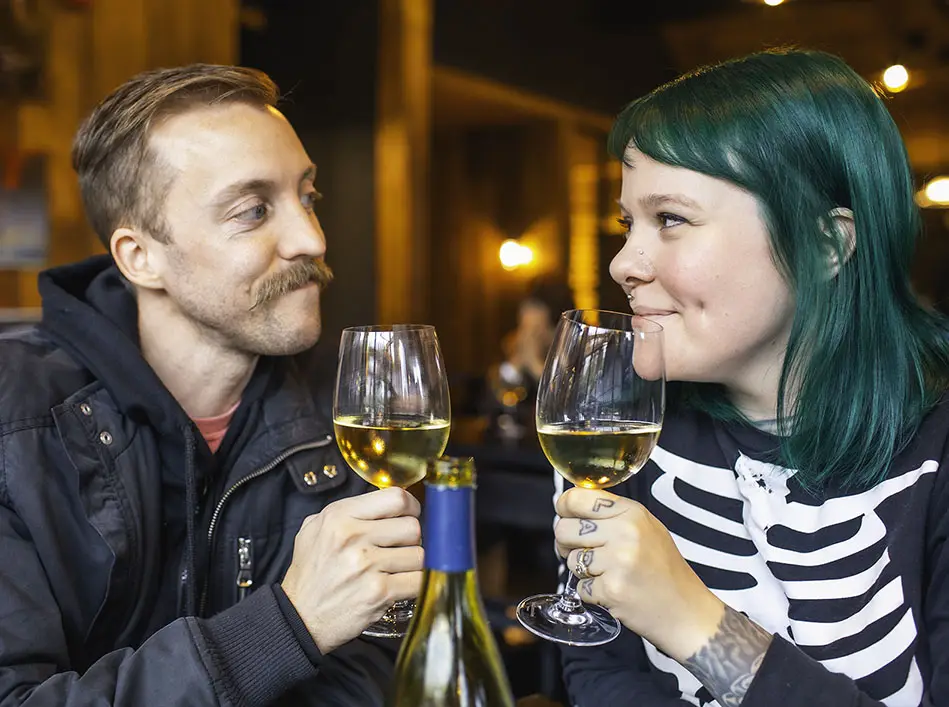 Two visitors toasting with wine glasses at a Northeast Ohio winery